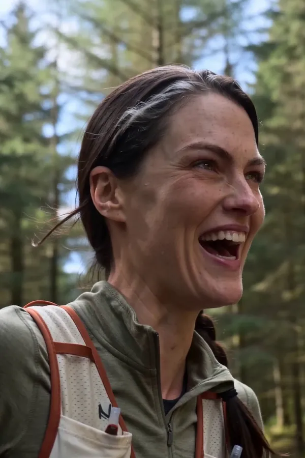 Tam Rook laughing on a forest trail