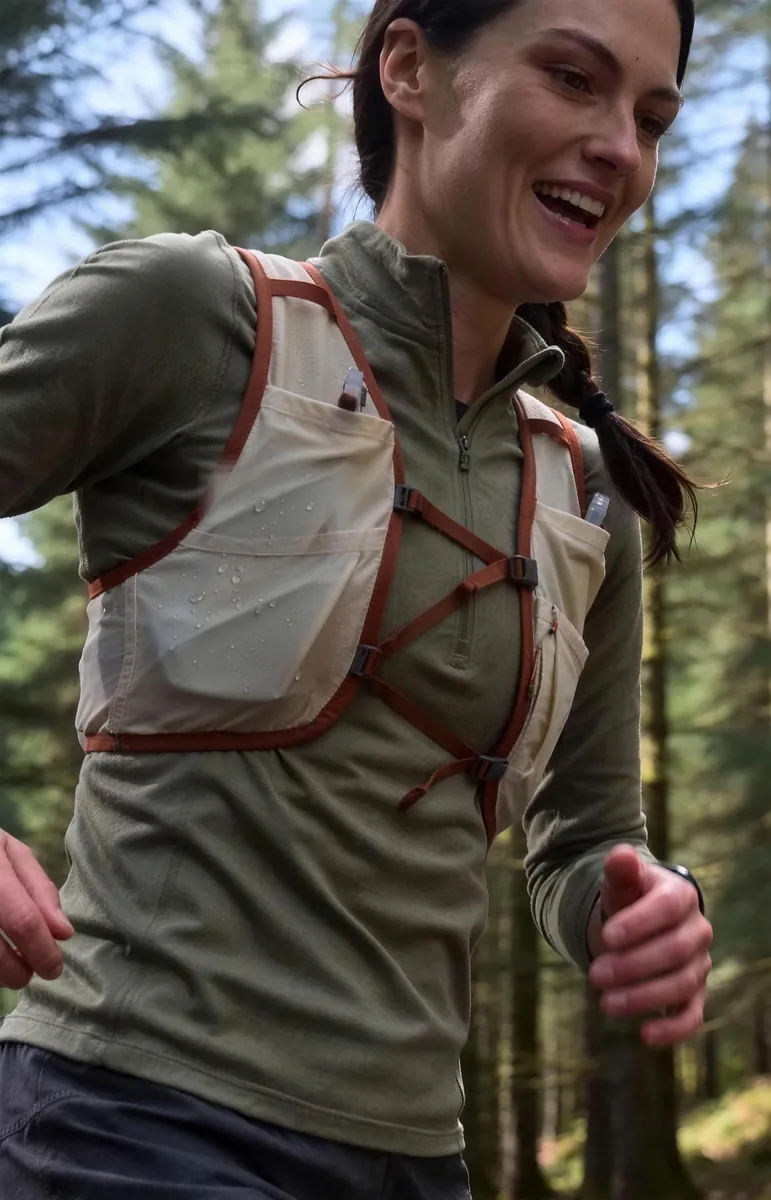 Tam laughing on a forest trail run